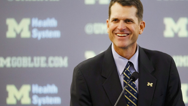 PHOTO: Jim Harbaugh climbs tree during recruiting visit