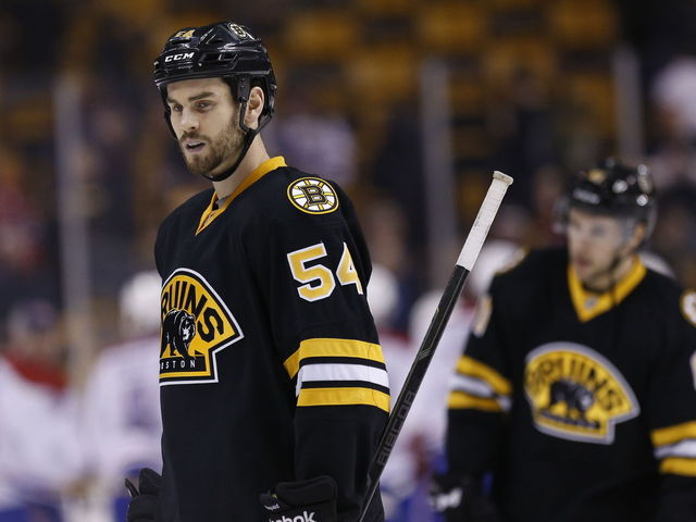 Bruins' McQuaid helped off after being taken hard into boards by Capitals' Sill
