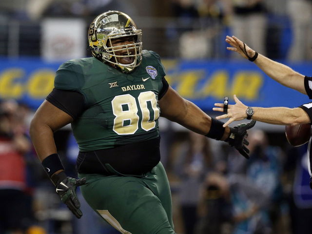VIDEO: Baylor's LaQuan McGowan has some difficulty putting jersey on
