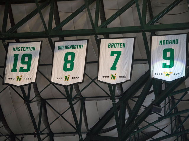 PHOTO: Neal Broten shows off Wild/North Stars alumni jersey