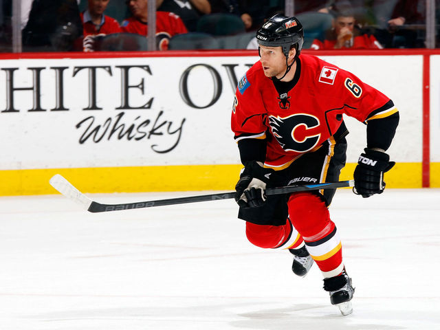 VIDEO: Flames' Wideman blasts through linesman on way to bench