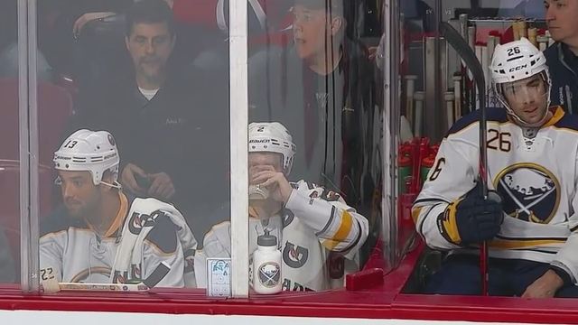 VIDEO: Sabres fans dressed like players swig beer next to bench