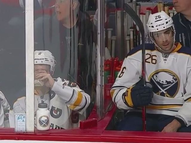 VIDEO: Sabres fans dressed like players swig beer next to bench
