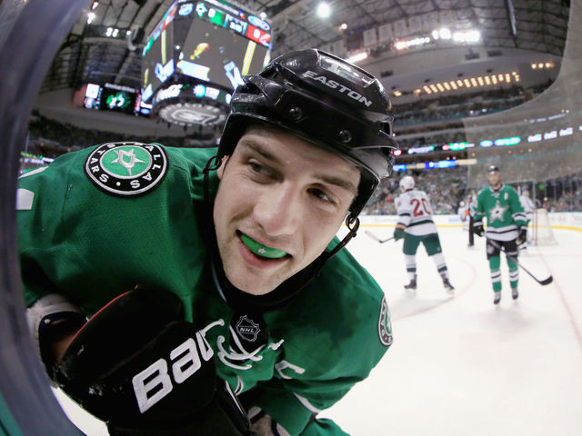 Jamie Benn poses for photo after drawing penalty