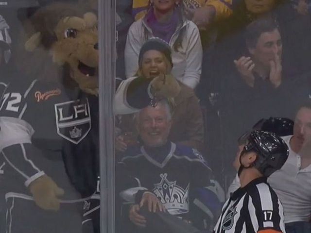 Kings' mascot offers pair of glasses to referee