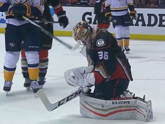 Neal slyly tries to poke stick through Gibson's mask