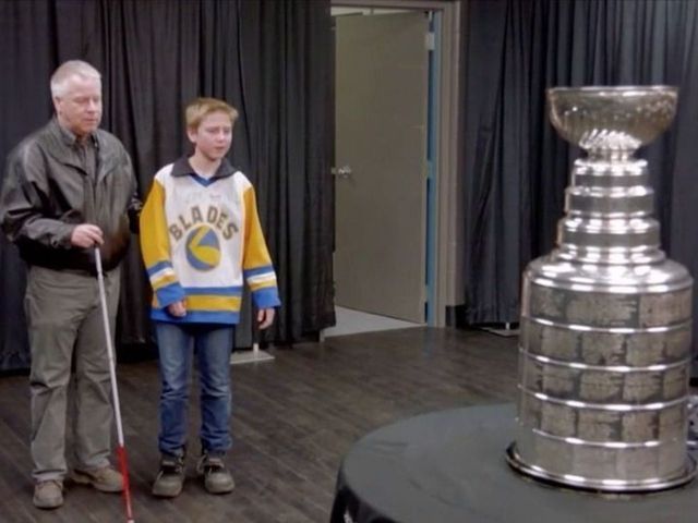 Blind man shares emotional moment with son while touching Stanley Cup