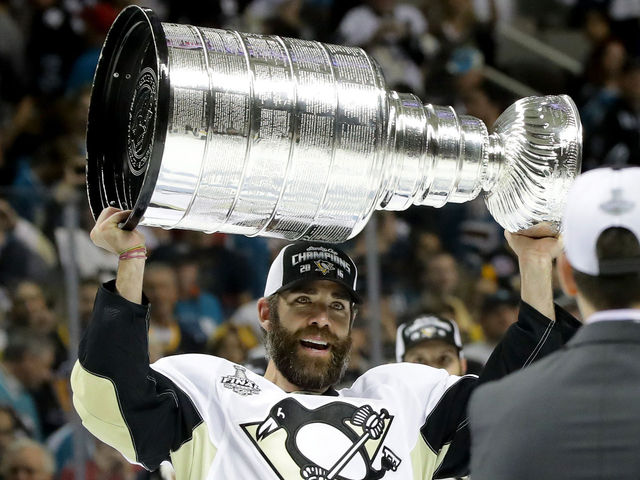 Retired Penguin Dupuis lifts Stanley Cup in full uniform