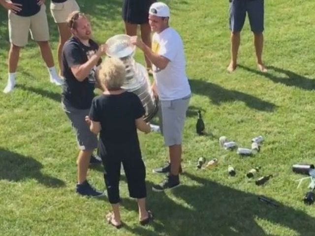 Kessel's grandma samples champagne from Stanley Cup