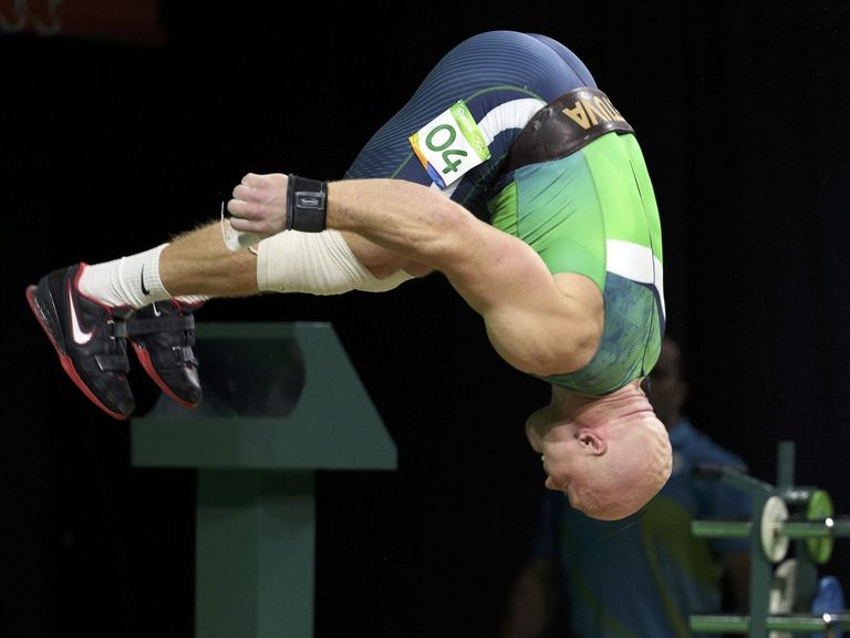Watch Lithuanian weightlifter flawlessly backflips after winning
