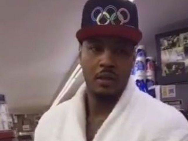 Melo strolls to corner store in custom bathrobe
