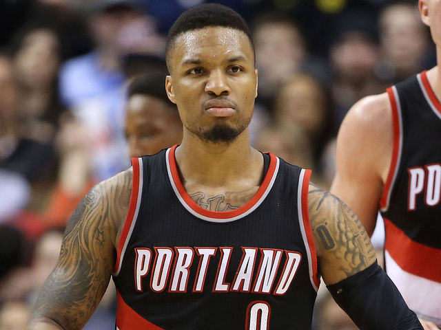 Watch: Lillard barrels into 1st row, takes out Wolves' owner