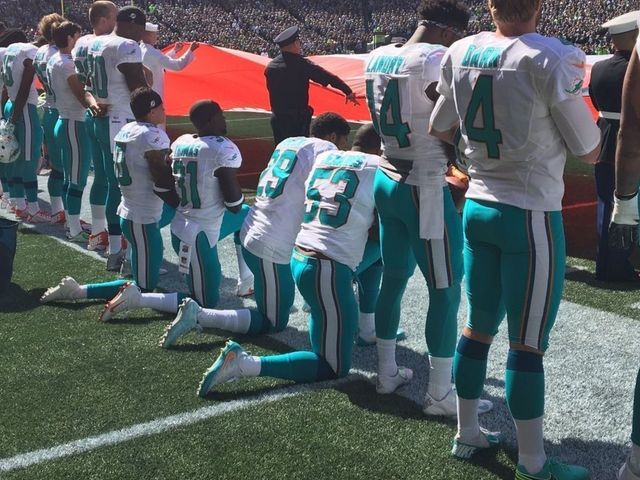 Several Dolphins kneel for national anthem, Seahawks link arms