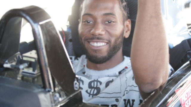 Smiley Kawhi Leonard drives with Mario Andretti at IndyCar finale