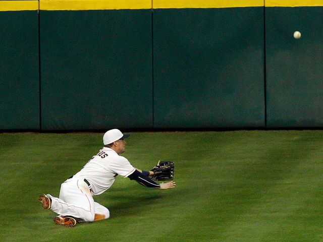 Houston Astros center fielder Michael Bourn catches a fly ball on