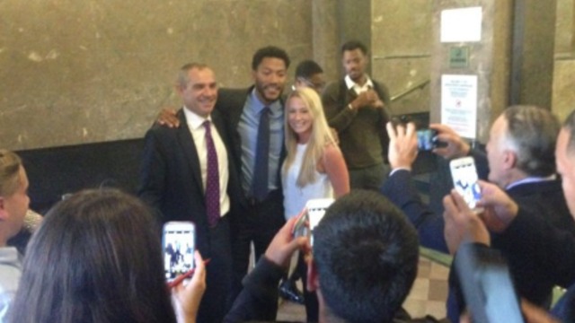 Rose poses for pictures with jurors after being cleared in civil suit