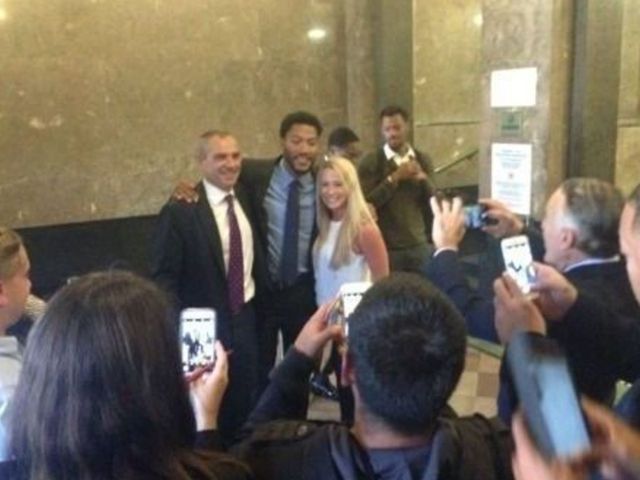 Rose poses for pictures with jurors after being cleared in civil suit