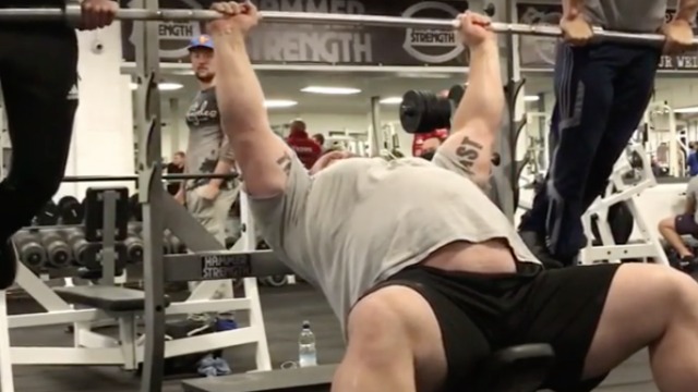 Strongman Eddie Hall bench-presses 2 men
