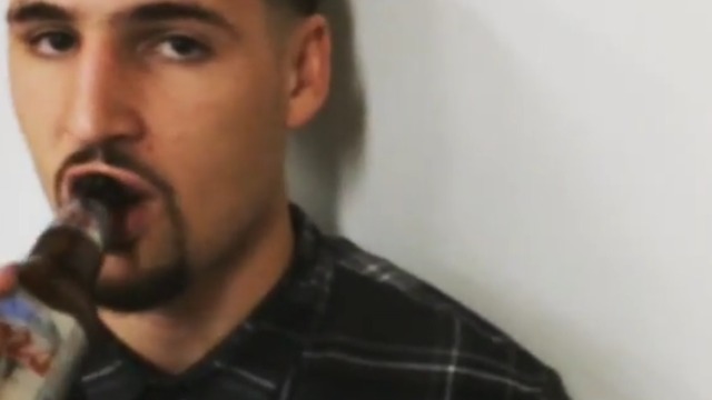 Klay Thompson sips beer as reporter asks him questions