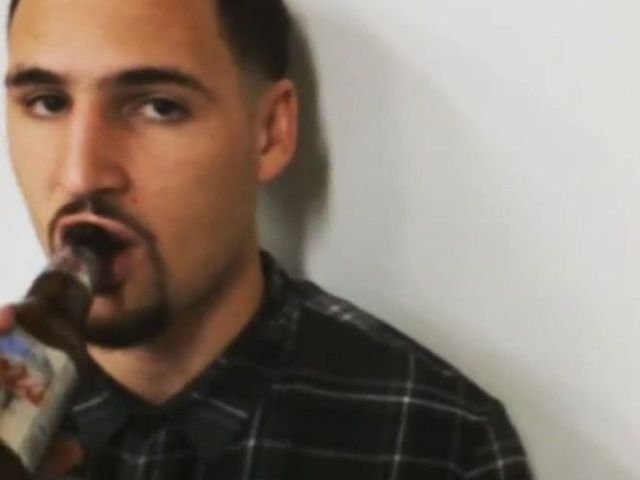 Klay Thompson sips beer as reporter asks him questions
