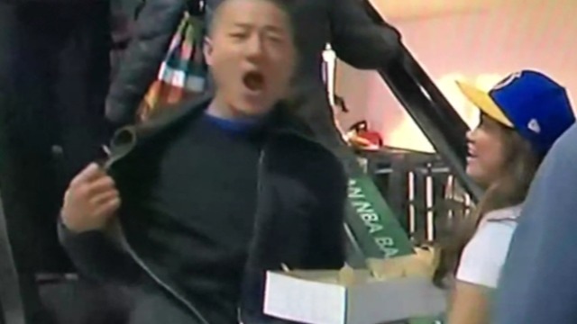 Fan enthusiastically flashes blank T-shirt during Warriors broadcast