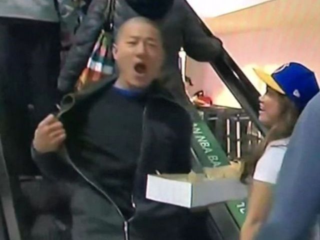 Fan enthusiastically flashes blank T-shirt during Warriors broadcast