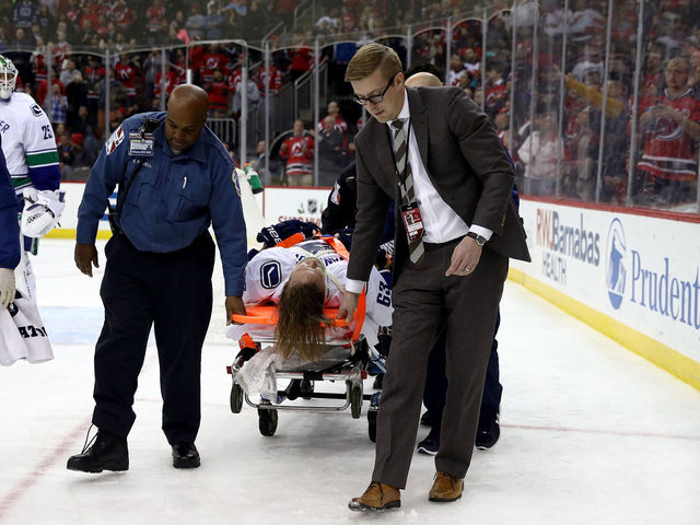 Canucks' Larsen stretchered off after hit from Devils' Hall