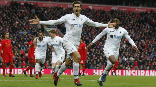 Lowly Swansea stuns Liverpool as rare Anfield loss dents title bid