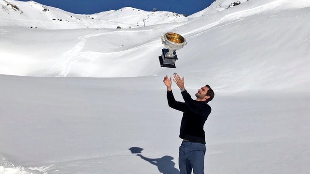 Federer takes Australian Open trophy to top of Swiss Alps