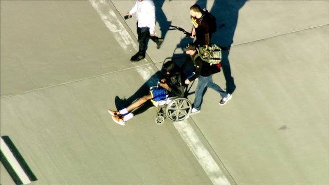 Durant returns to Oakland in wheelchair