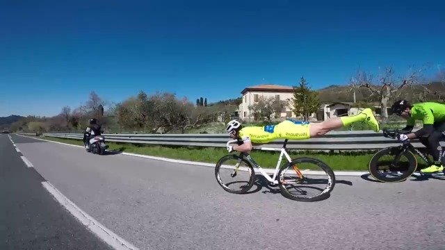 Watch: Cyclist cruises past competition while riding Superman-style