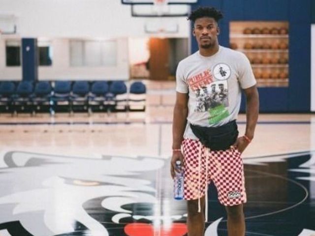 Jimmy Butler poses at 'new home' in Timberwolves' gym