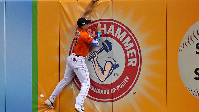 Watch: Marlins' Stanton loses glove over wall on attempted leaping catch