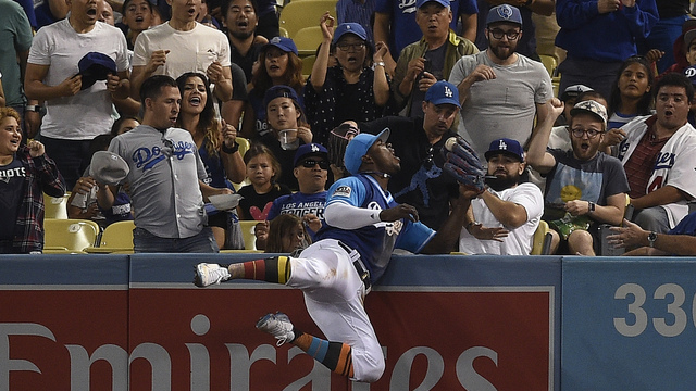 Watch: Puig reaches into stands, crashes into wall to rob HR