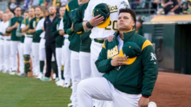 A's catcher Maxwell kneels for national anthem
