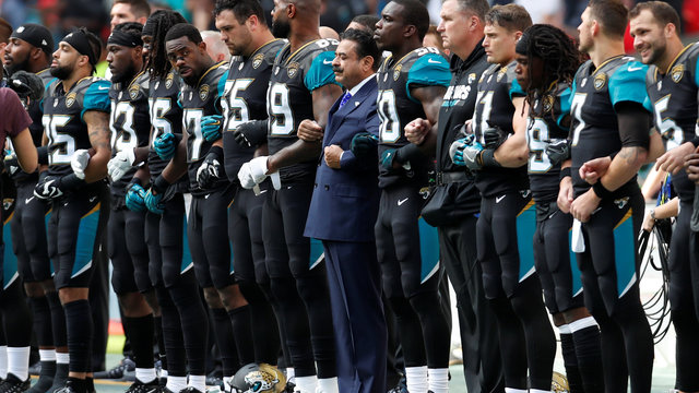 Jaguars owner takes part as both teams protest before London game