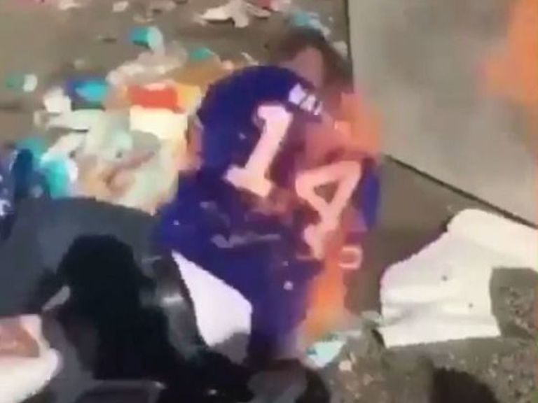 Watch Bills fan sets himself on fire after jumping through burning