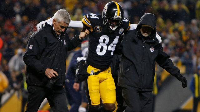 PITTSBURGH, PA - DECEMBER 17: Antonio Brown #84 of the Pittsburgh Steelers is walked off the field by trainers after landing awkwardly while attempting to catch a pass in the second quarter during the game against the New England Patriots at Heinz Field on December 17, 2017 in Pittsburgh, Pennsylvania. (Photo by Justin K. Aller/Getty Images)