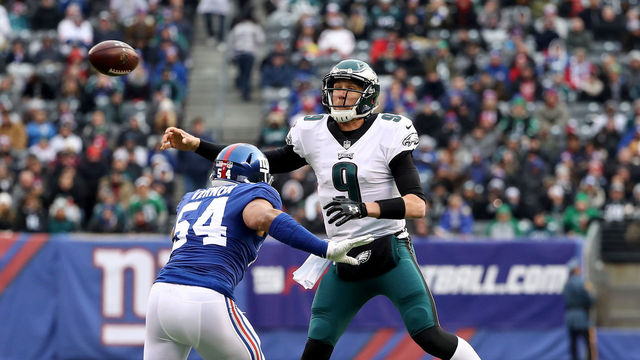 EAST RUTHERFORD, NEW JERSEY - DECEMBER 17: Nick Foles #9 of the Philadelphia Eagles passes under pressure from Olivier Vernon #54 of the New York Giants in the third quarter at MetLife Stadium on December 17, 2017 in East Rutherford, New Jersey. (Photo by Elsa/Getty Images)