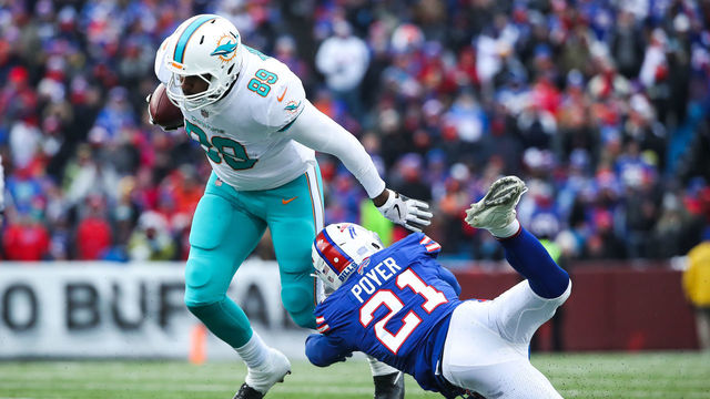 ORCHARD PARK, NY - DECEMBER 17: Julius Thomas #89 of the Miami Dolphins runs the ball as Jordan Poyer #21 of the Buffalo Bills attempts to tackle him during the third quarter on December 17, 2017 at New Era Field in Orchard Park, New York. (Photo by Tom Szczerbowski/Getty Images)