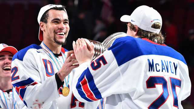 MONTREAL, QC - JANUARY 05: Charlie McAvoy #25 hands over the IIHF trophy to teammate Jordan Greenway #12 of Team United States during the 2017 IIHF World Junior Championship gold medal game against Team Canada at the Bell Centre on January 5, 2017 in Montreal, Quebec, Canada. Team United States defeated Team Canada 5-4 in a shootout and win the gold medal round. (Photo by Minas Panagiotakis/Getty Images)