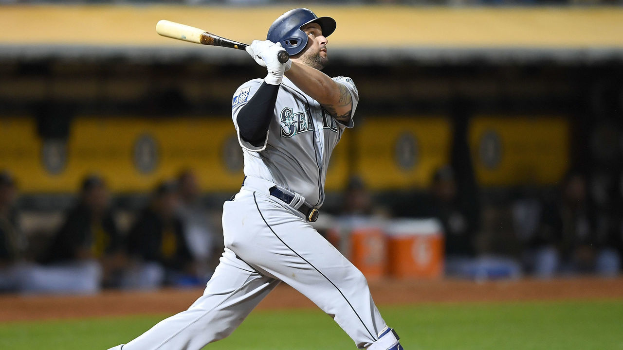 OAKLAND, CA - SEPTEMBER 26: Yonder Alonso #10 of the Seattle Mariners swings and watches the flight of his ball as he hits a two-run homer against the Oakland Athletics in the top of the fourth inning at Oakland Alameda Coliseum on September 26, 2017 in Oakland, California.