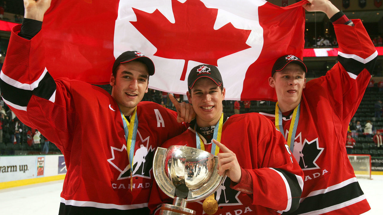 GRAND FORKS, ND - JANUARY 4: Corey Perry #24, Sidney Crosby #9 and Patrice Begeron #37 hold the World Junior Championship trophy after Canada won the gold medal game 6-1 over Russia at the World Junior Hockey Championships on January 4, 2005 at the Ralph Englestad Arena in Grand Forks, North Dakota.