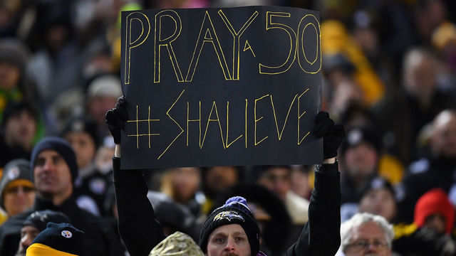 PITTSBURGH, PA - DECEMBER 10: A Baltimore Ravens fan holds up a sign honoring Ryan Shazier #50 of the Pittsburgh Steelers who was injured in a game last week during the game at Heinz Field on December 10, 2017 in Pittsburgh, Pennsylvania.