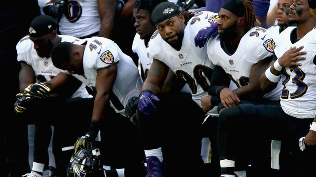 LONDON, ENGLAND - SEPTEMBER 24: Baltimore Ravens players kneel for the American National anthem during the NFL International Series match between Baltimore Ravens and Jacksonville Jaguars at Wembley Stadium on September 24, 2017 in London, England.