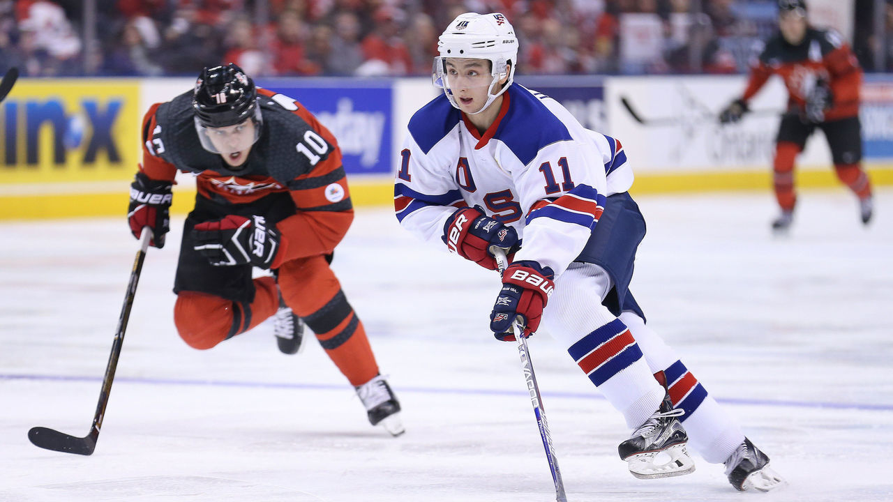 TORONTO,ON - DECEMBER 31: Patrick Harper #11 of Team USA skates wide against Kale Clague #10 of Team Canada during a preliminary round game in the 2017 IIHF World Junior Hockey Championship at the Air Canada Centre on December 31, 2016 in Toronto, Ontario, Canada. The USA defeated Canada 3-1.