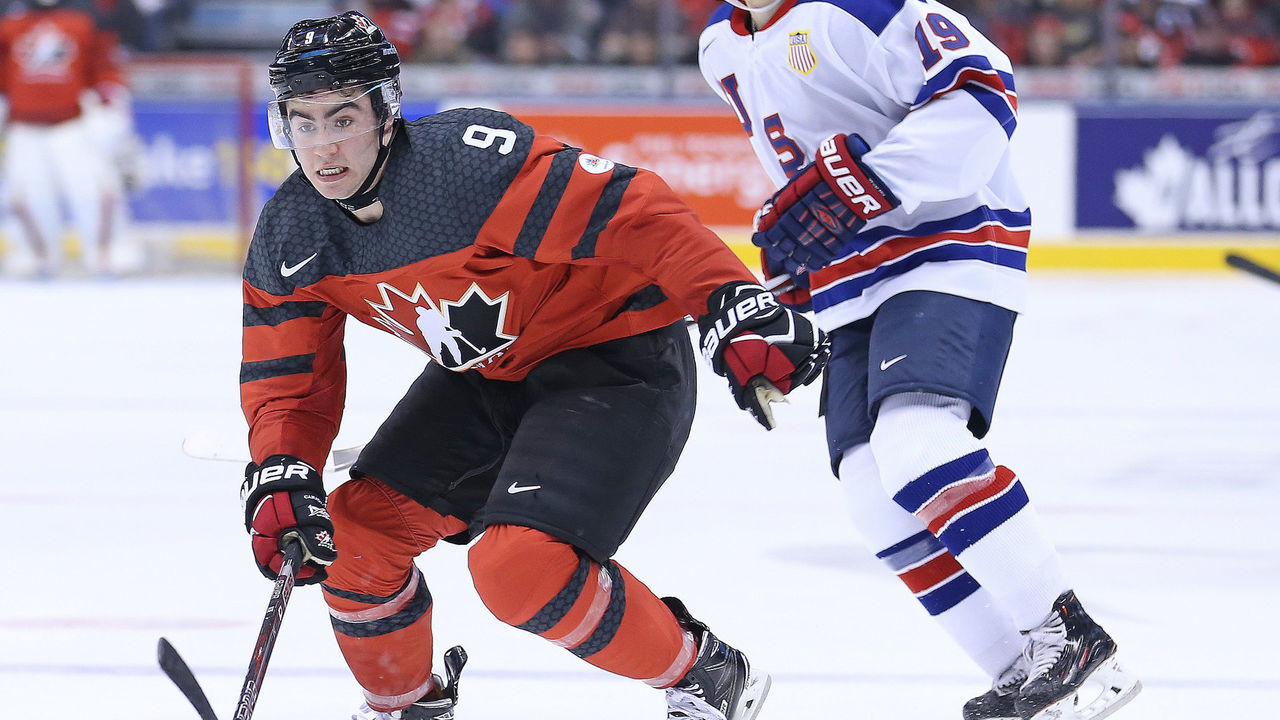 TORONTO,ON - DECEMBER 31: Dillon Dube #9 of Team Canada skates on a forecheck in front of Clayton Keller #19 of Team USA during a preliminary round game in the 2017 IIHF World Junior Hockey Championship at the Air Canada Centre on December 31, 2016 in Toronto, Ontario, Canada. The USA defeated Canada 3-1.