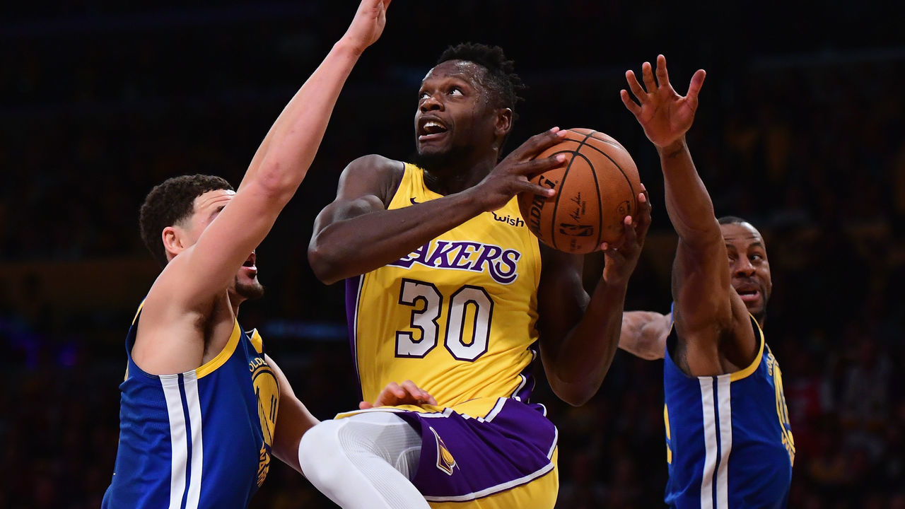 LOS ANGELES, CA - DECEMBER 18: Julius Randle #30 of the Los Angeles Lakers drives between Klay Thompson #11 and Andre Iguodala #9 during a 116-114 Warrior overtime win at Staples Center on December 18, 2017 in Los Angeles, California.