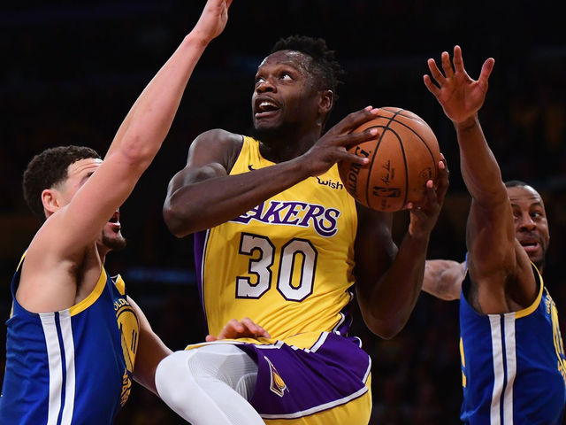 LOS ANGELES, CA - DECEMBER 18: Julius Randle #30 of the Los Angeles Lakers drives between Klay Thompson #11 and Andre Iguodala #9 during a 116-114 Warrior overtime win at Staples Center on December 18, 2017 in Los Angeles, California.