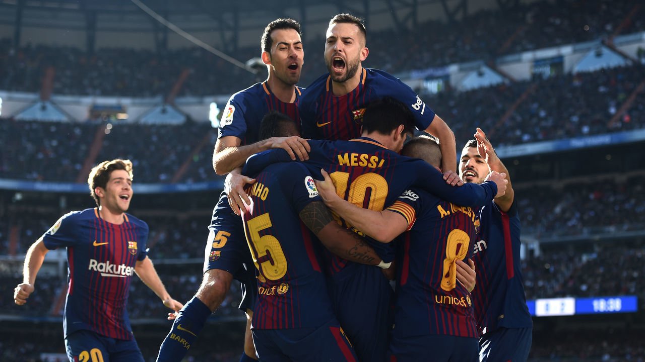 MADRID, SPAIN - DECEMBER 23: Lionel Messi of Barcelona celebrates after scoring his sides second goal with his team mates during the La Liga match between Real Madrid and Barcelona at Estadio Santiago Bernabeu on December 23, 2017 in Madrid, Spain.